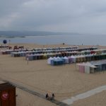Rows and rows of colourful - and empty - tents on the beach at rainy Nazaré.