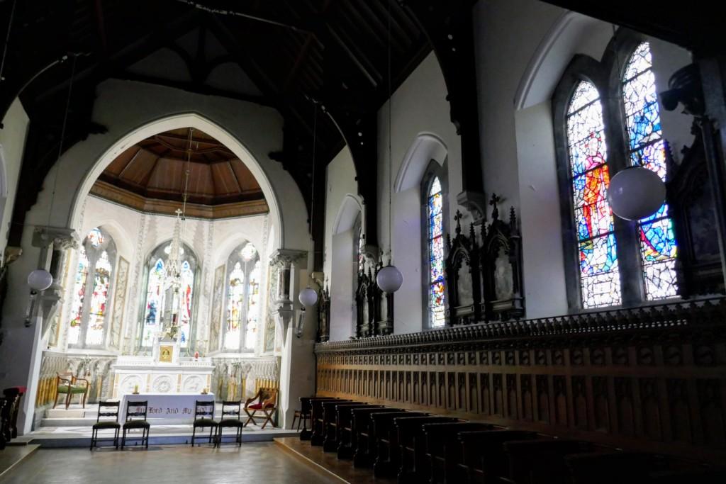 Inside the Chapel of the Sacred Heart at the Díseart Institute of Irish Spirituality and Culture. Three of the Harry Clarke windows are on the right. The windows behind the altar were installed in 1899 and made by Franz Mayer Stained Glass of Munich, Germany. 