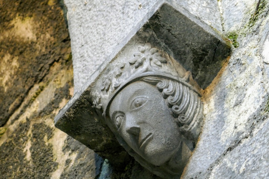 Carved head of a king way up on the corbel of an arch on the south side of the nave.
